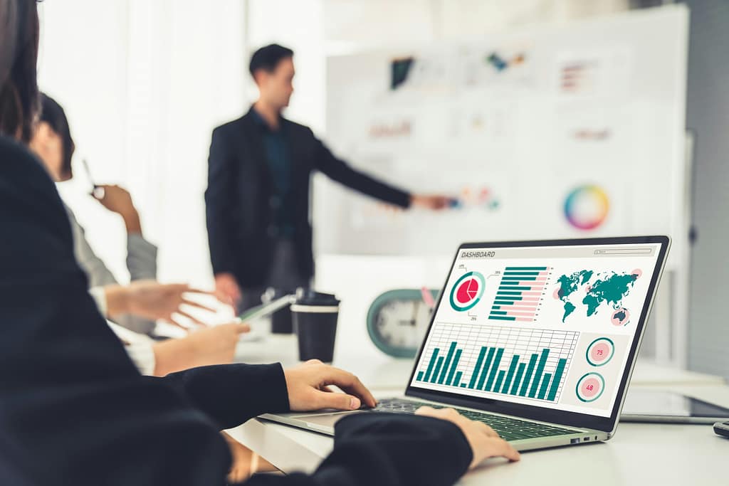 Woman in business meeting using laptop for data analysis