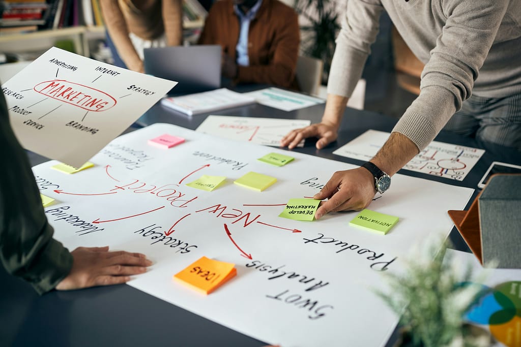 Close-up of creative marketing team brainstorming while working on new business project in the office